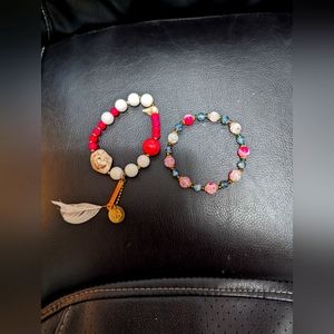 2 Bracelets.  One is a Rocking Vibe Brand with Natural stones ,pearl and feather